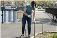 Woman Hammering Post Into Ground